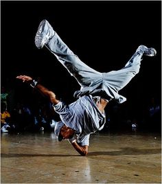 a man is doing a handstand on the floor with his feet in the air