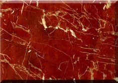 a red marble textured background with gold veining and white lines on the edges