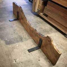 a piece of wood sitting on top of a floor next to some drawers and cabinets