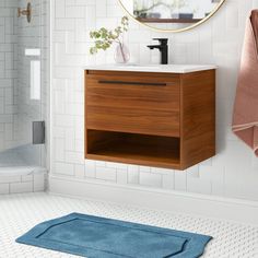 a bathroom with a sink, mirror and towel on the wall next to toiletries