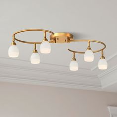 an image of a bathroom light fixture with five lights on the bottom and one in the middle