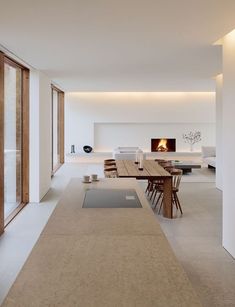 a dining room with a table and chairs next to a fire place