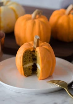 a white plate topped with a cut in half pumpkin