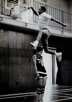 a man jumping in the air while holding a basketball