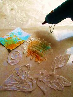 some plastic objects are laying on the floor next to a pen and paper cutters