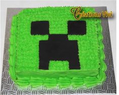 a cake with green frosting that looks like a minecraft creeper face on it