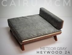 a couch that is sitting on top of a wooden frame with the words metro gray in front of it