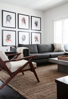 a living room filled with furniture and pictures on the wall