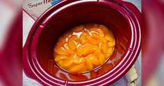 a crock pot filled with food sitting on top of a table next to a bag of butter