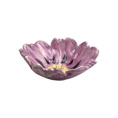 a purple flower shaped bowl sitting on top of a table