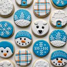 decorated cookies with frosting and icing are arranged in the shape of snowmen