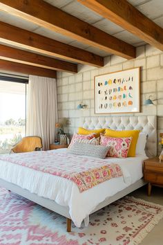 a bedroom with a large bed and colorful rugs on the floor in front of a window