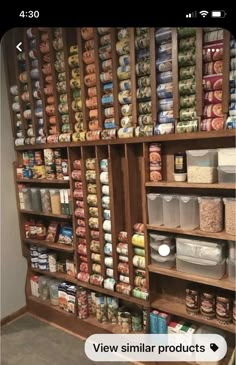 an organized pantry with lots of food items on the shelves and in bins for storage