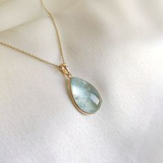 This stunning pendant is set in 14K Solid Yellow Gold with Natural Aquamarine with utmost precision. It is an unique gemstone pendant for nearly every occasion and is completely hassle-free jewelry. ITEM DETAILS * Gem: Aquamarine * Gem Size: 14X20mm * Gem Shape: Pear * Gem Weight: 12.65 carats * Gold Purity: 14KT  * Gold Weight: 0.60 gram * Total Weight of the Pendant: 3.13 gram The Gold purity is guaranteed and it comes with authentic 14KT gold hallmark. Since my items are handmade, they are absolutely nickel and lead free. CUSTOMIZATION * Gemstone customization is available and it can be substituted with a gem of your choice. Kindly message me for the same. PACKAGING * The Pendant comes with layers of safe and secure wrapping along with Free handmade jewelry box with every purchase. ➡️He Aquamarine Stone Necklace, Pisces And Aquarius, Aquamarine Gem, Rainbow Moonstone Necklace, Handmade Jewelry Box, Large Pendant Necklace, Glass Beads Jewelry, Aquamarine Pendant, Aquamarine Jewelry