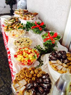 a buffet table filled with lots of different types of foods and desserts on it