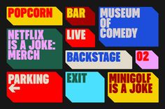 multiple colored signs with different words on them that say popcorn, netflix, live, and backstage