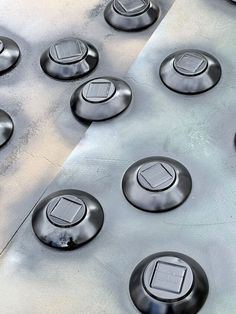 there are many buttons on the side of a metal surface that looks like it is made out of steel