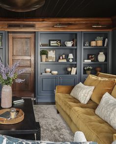 a living room filled with furniture and bookshelves