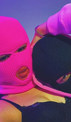 two women wearing pink and black hats with their faces covered by fake lips are posing for the camera