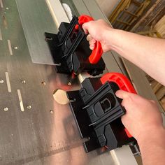 a person is using a tool to cut into pieces on a piece of metal sheet