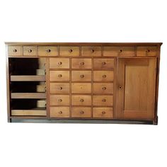 a large wooden cabinet with many drawers