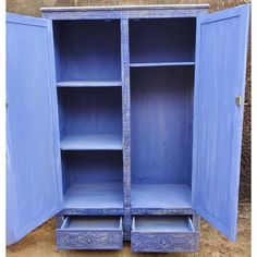 an old blue cabinet with two open doors