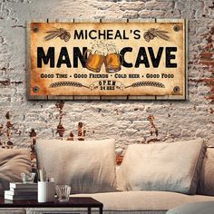 a couch in front of a brick wall with a sign on it that says, michael's mancave good times good friends cold beer good food