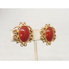 This is part of Chairish’s Costume Jewelry assortment.  1960s goldtone scrollwork with cabochon faux-carnelian centers clip back earrings. Marked "DeNicola." Measure: 1 1/8 inches long by 1 inch wide. Excellent condition. Vintage Cabochon Earrings For Formal Occasions, Mid-century Gold Jewelry With Cabochon, Vintage Carnelian Jewelry With Polished Finish, Vintage Cabochon Clip-on Earrings For Formal Occasions, Mid-century Gold Cabochon Jewelry, Vintage Formal Clip-on Cabochon Earrings, 1960s Earrings, 1960s Sounthern Vintage Earrings Jewelry, Carved Carnelian Vintage Jewelry