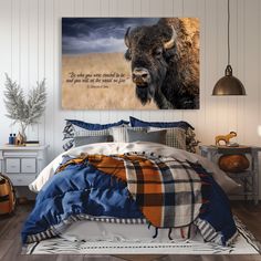 a bedroom with a buffalo painting on the wall