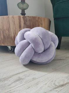 a stuffed animal sitting on top of a wooden floor