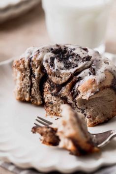 a piece of cinnamon roll on a plate with a fork