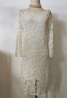 a white lace dress on a mannequin