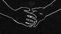 two hands holding each other in front of a black background with snow falling on the ground