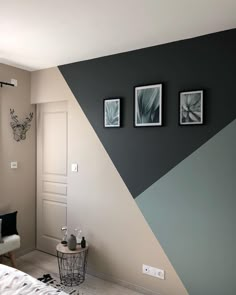 a bedroom with two pictures on the wall