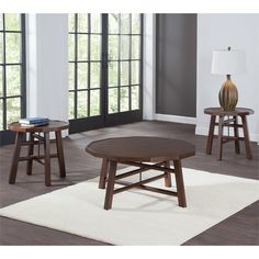 three wooden tables sitting on top of a white rug