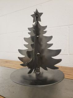 a metal christmas tree sitting on top of a table