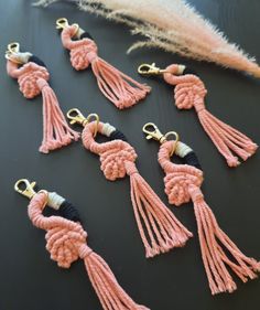 pink and black tasselled earrings on a table