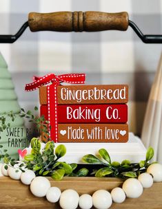 a sign that says gingerbread baking co and made with love on top of a table