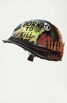 a helmet with the words born to kill written on it is flying in the air