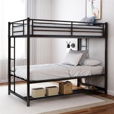 a black bunk bed with white sheets and pillows