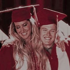 a man and woman in graduation caps and gowns hugging each other with smiles on their faces