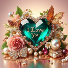 a green heart surrounded by jewels and flowers with the words i love you written on it