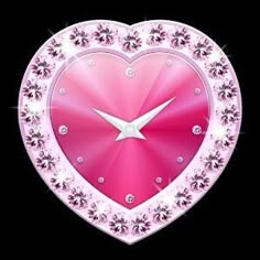 a pink heart shaped clock with diamonds on it