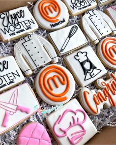 some decorated cookies in a box with writing on them and magnets to the side