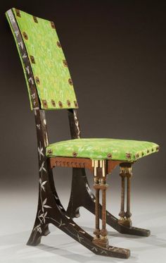 a green chair sitting on top of a wooden table