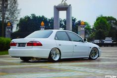 a white car parked in front of a monument