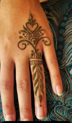 a woman's hand with a henna tattoo on it