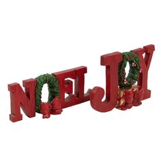 the word joy is made out of red wood and decorated with wreaths on it