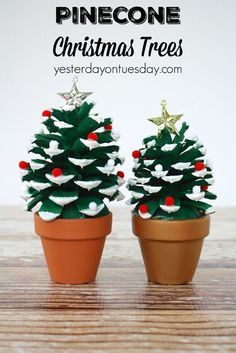 two small pinecone christmas trees sitting on top of each other in clay pots