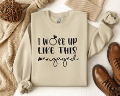 a sweater with the words i woke up like this engaged on it next to some shoes